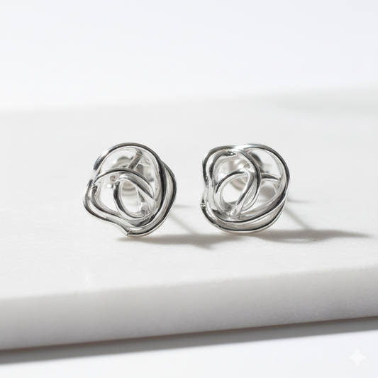 Minimalist silver rose stud earrings on white background — Nounou Studio