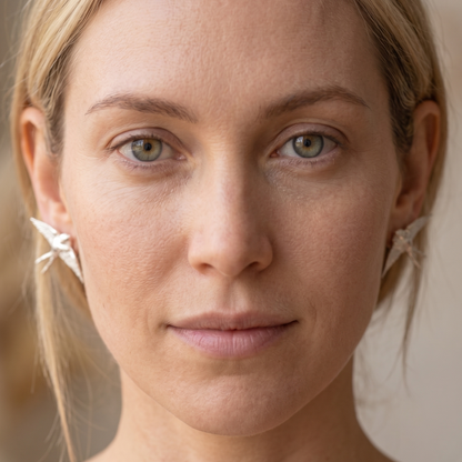 Handcrafted swallow stud earrings worn by a model — Nounou Studio"