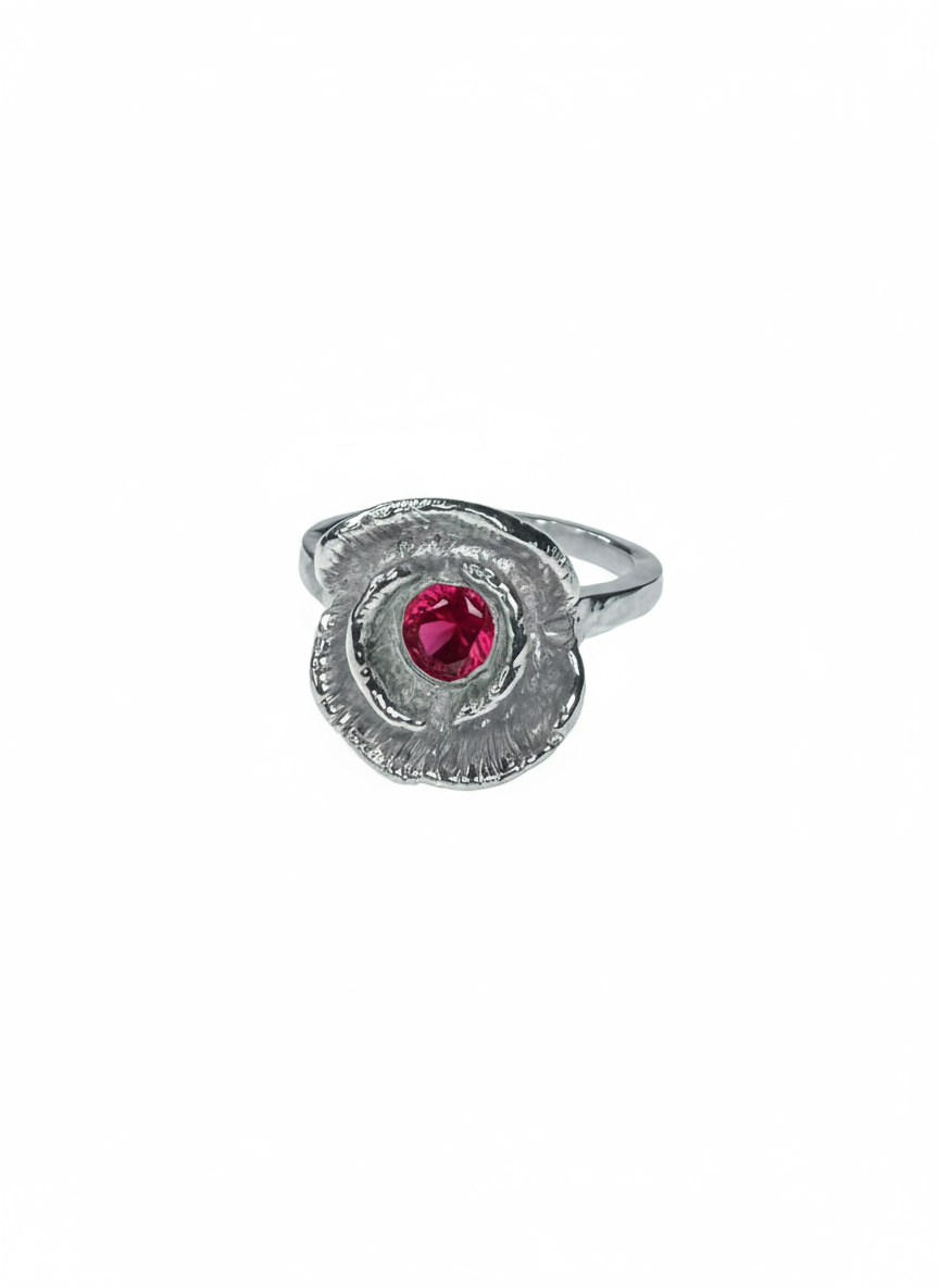 Silver ring with a red ruby on a white background