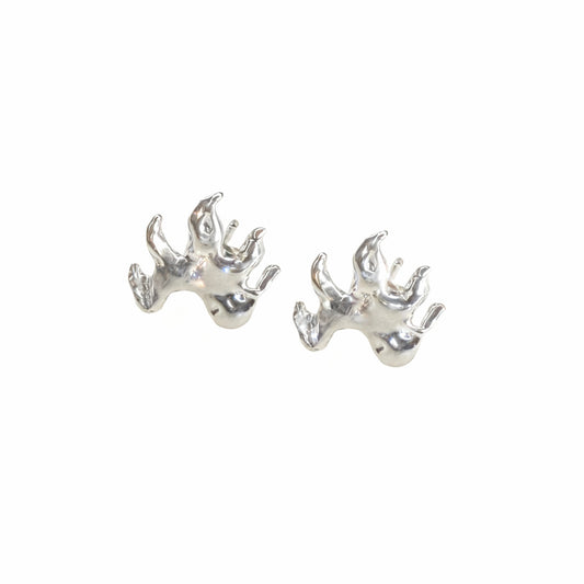 Pair of silver flame-shaped earrings on a white background