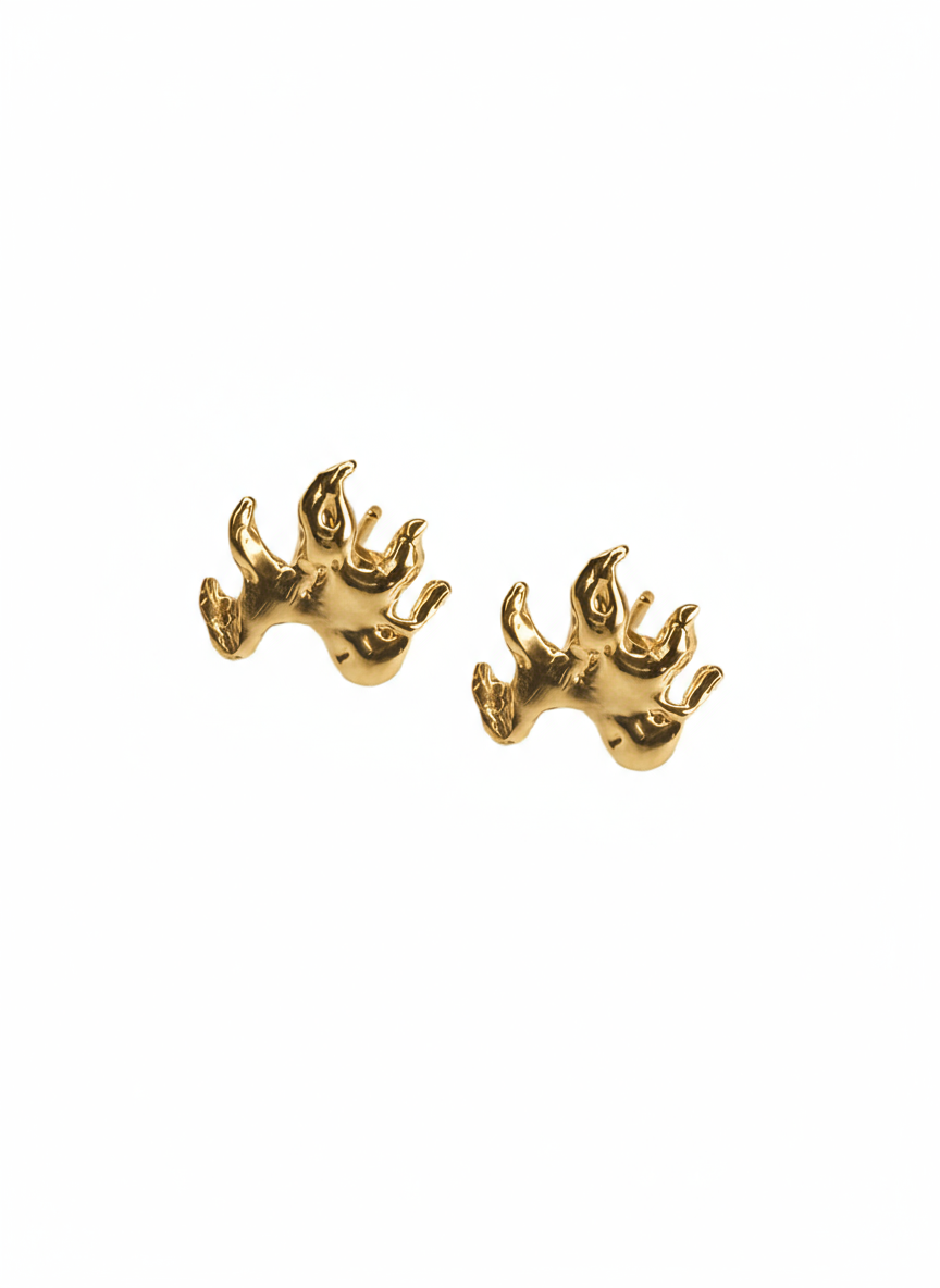 Gold flame earrings on a white background