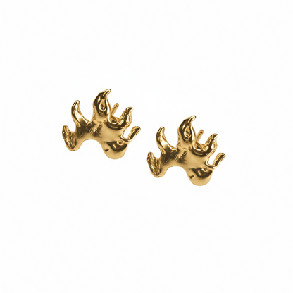 Gold flame earrings on a white background