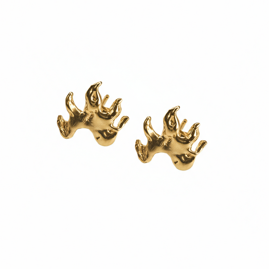 Gold flame earrings on a white background