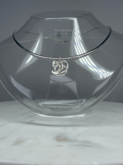 Close-up of handcrafted silver rose pendant showing petal detail — Nounou Studio