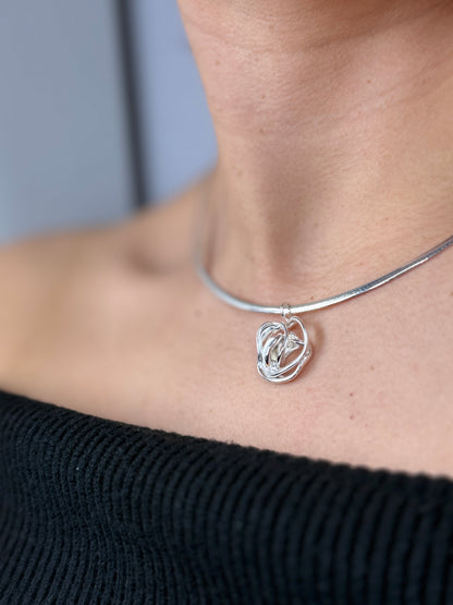 Sterling silver rose necklace pendant, side view on gray background — Nounou Studio