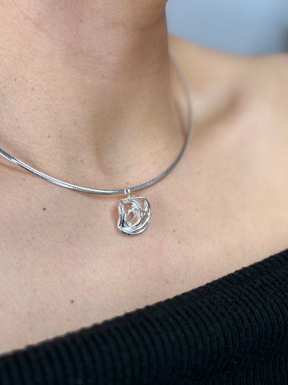 Minimalist silver rose necklace worn by a model, lifestyle shot — Nounou Studio
