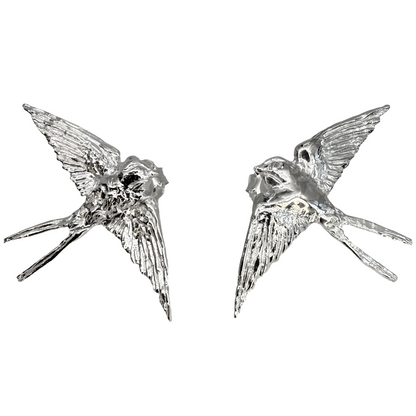 Sterling silver swallow stud earrings on white background — Nounou Studio