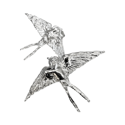 Sterling silver swallow stud earrings on white background — Nounou Studio