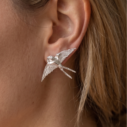 Silver swallow earrings, close-up showing wing detail — Nounou Studio