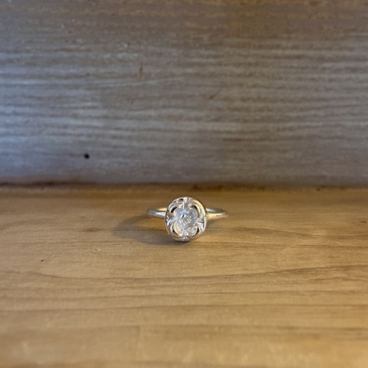 Silver lotte ring on a wooden surface