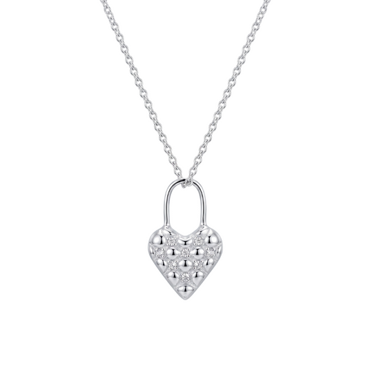 A silver quilted heart-shaped pendant necklace paved with small clear stones, suspended from a delicate silver chain against a solid white background.