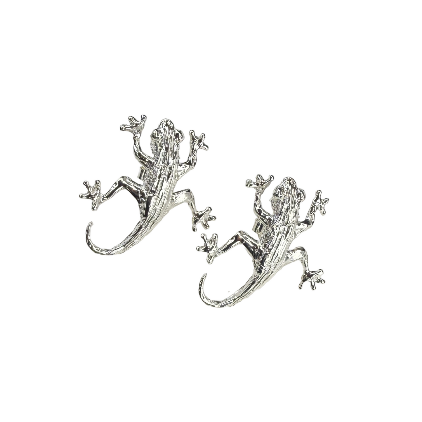 Silver lizard/gecko-shaped earrings on a white background