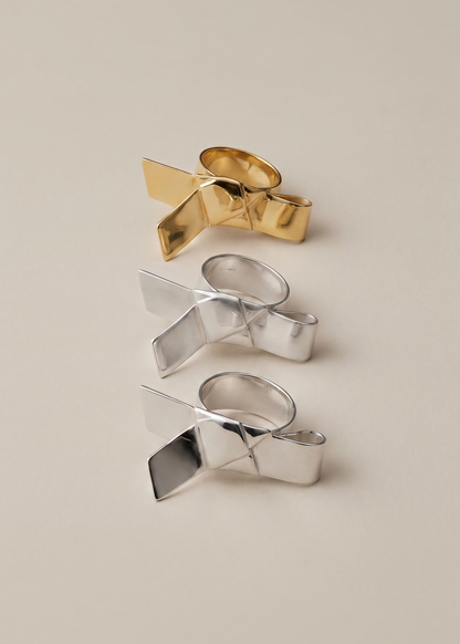 Gold and silver ring designs on a beige background