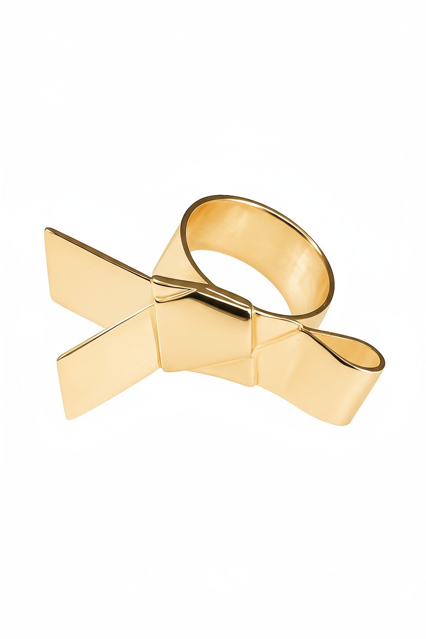 Gold bow-shaped ring on a white background