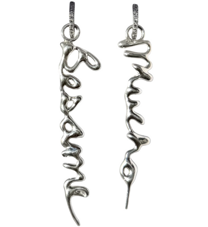 Silver earrings with 'Besame' and 'Mucho' inscriptions on a white background